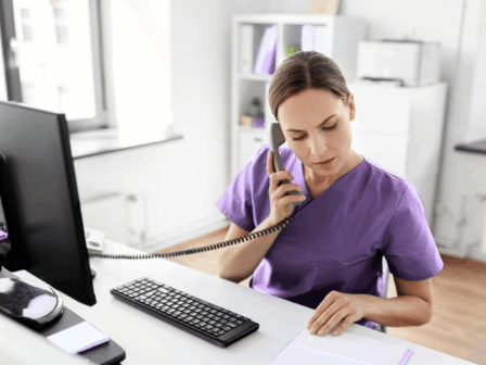 member of our office team at universal care services on the phone to a family about care