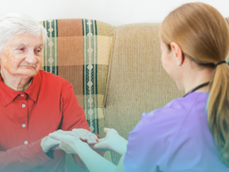 domiciliary care, client and carer, client is an older lady wearing a red jumper and grey hair. Care worker is wearing a lilac tunic
